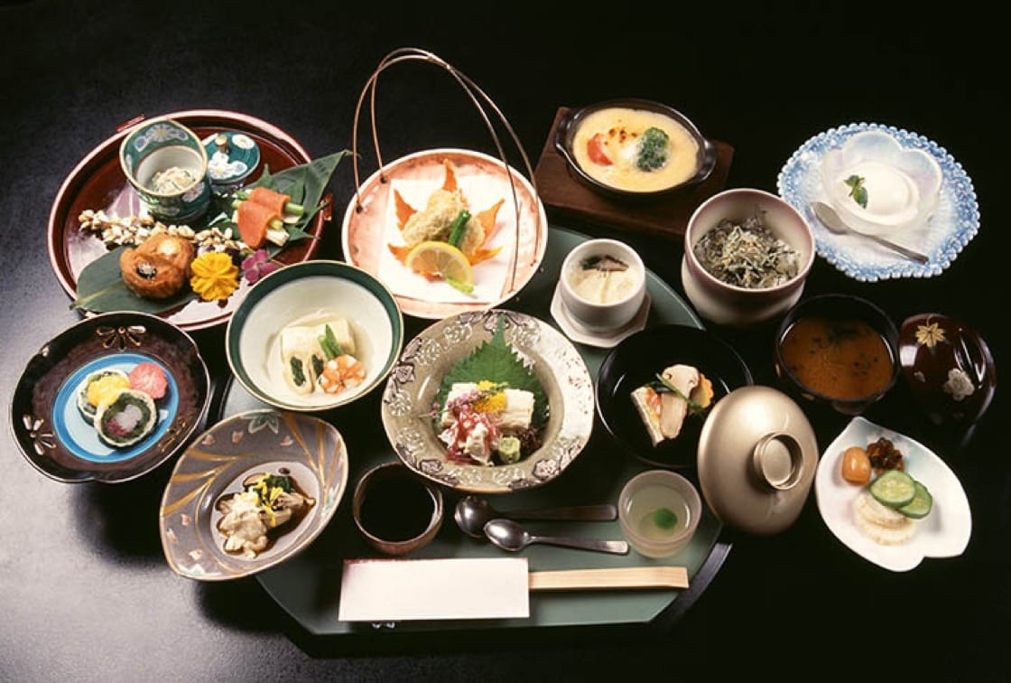 Elaborate multi-course kaiseki meal with seasonal dishes arranged on lacquer trays