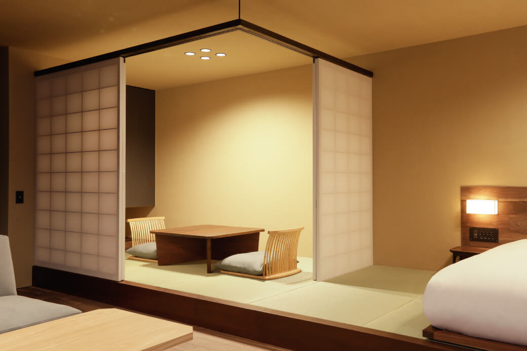 Minimalist tatami room with shoji panels and low table with floor chairs