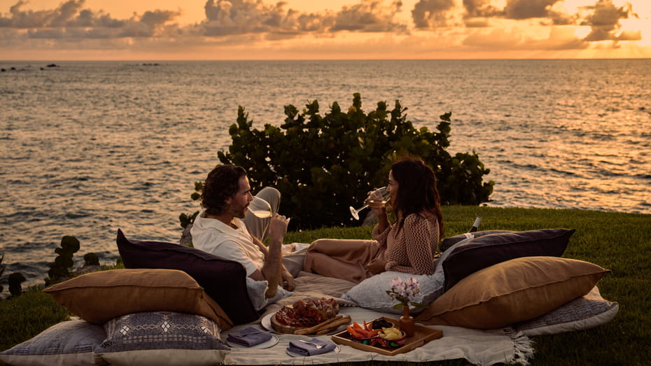 Couple sharing romantic moment on private beach at Four Seasons Punta Mita sunset