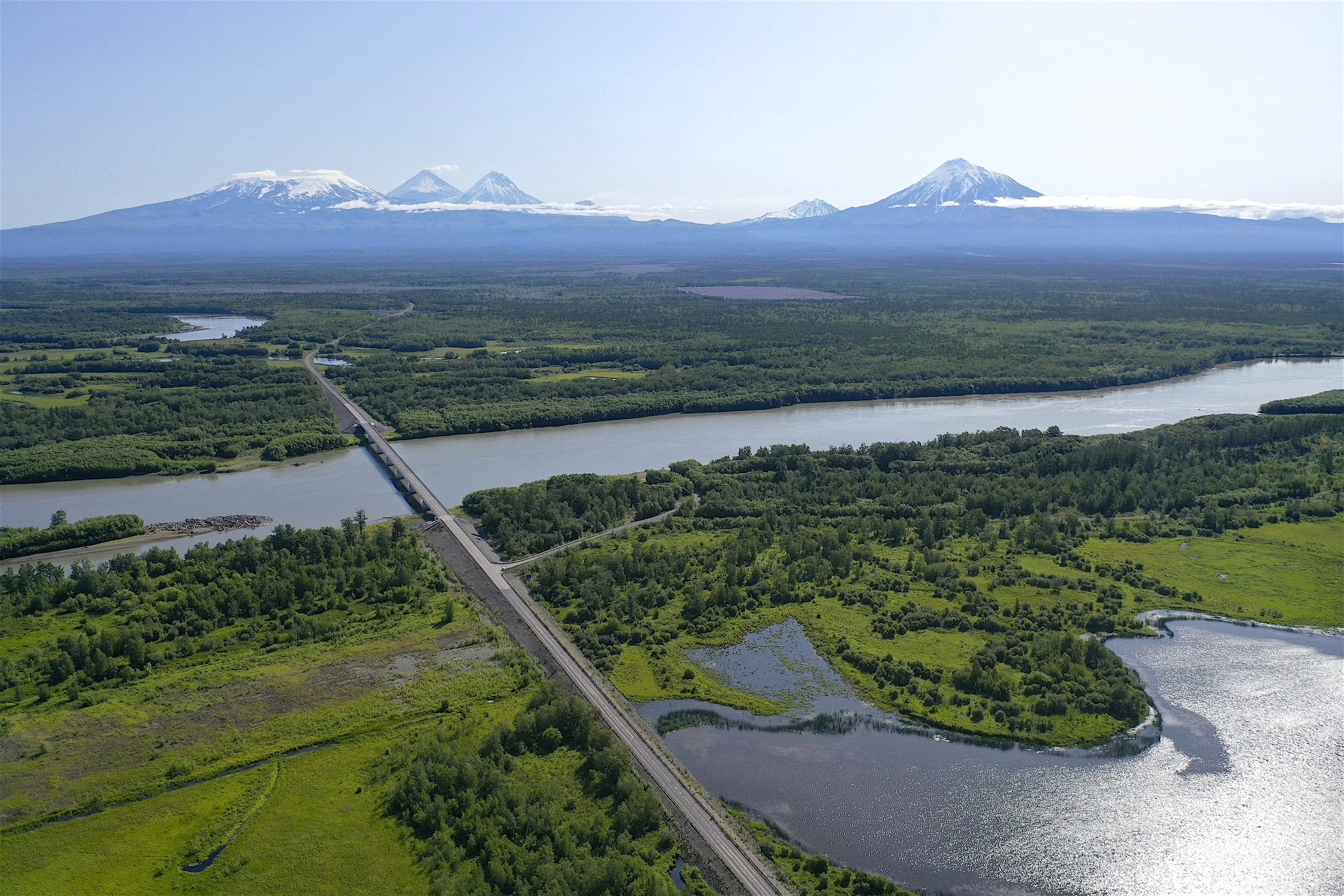 Drone view of Kamchatka River and volcanic peaks