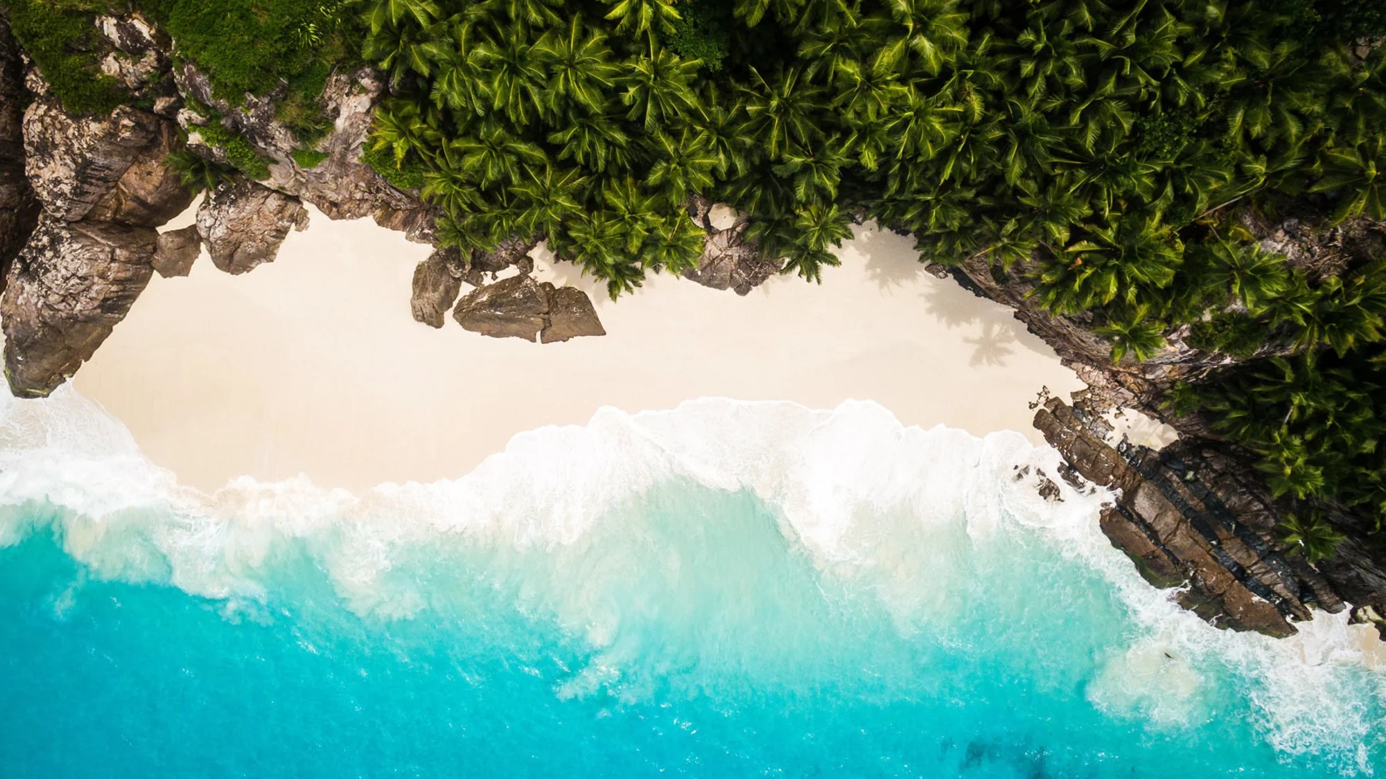 Aerial view of Fregate Island's diverse coastline and protected marine areas.