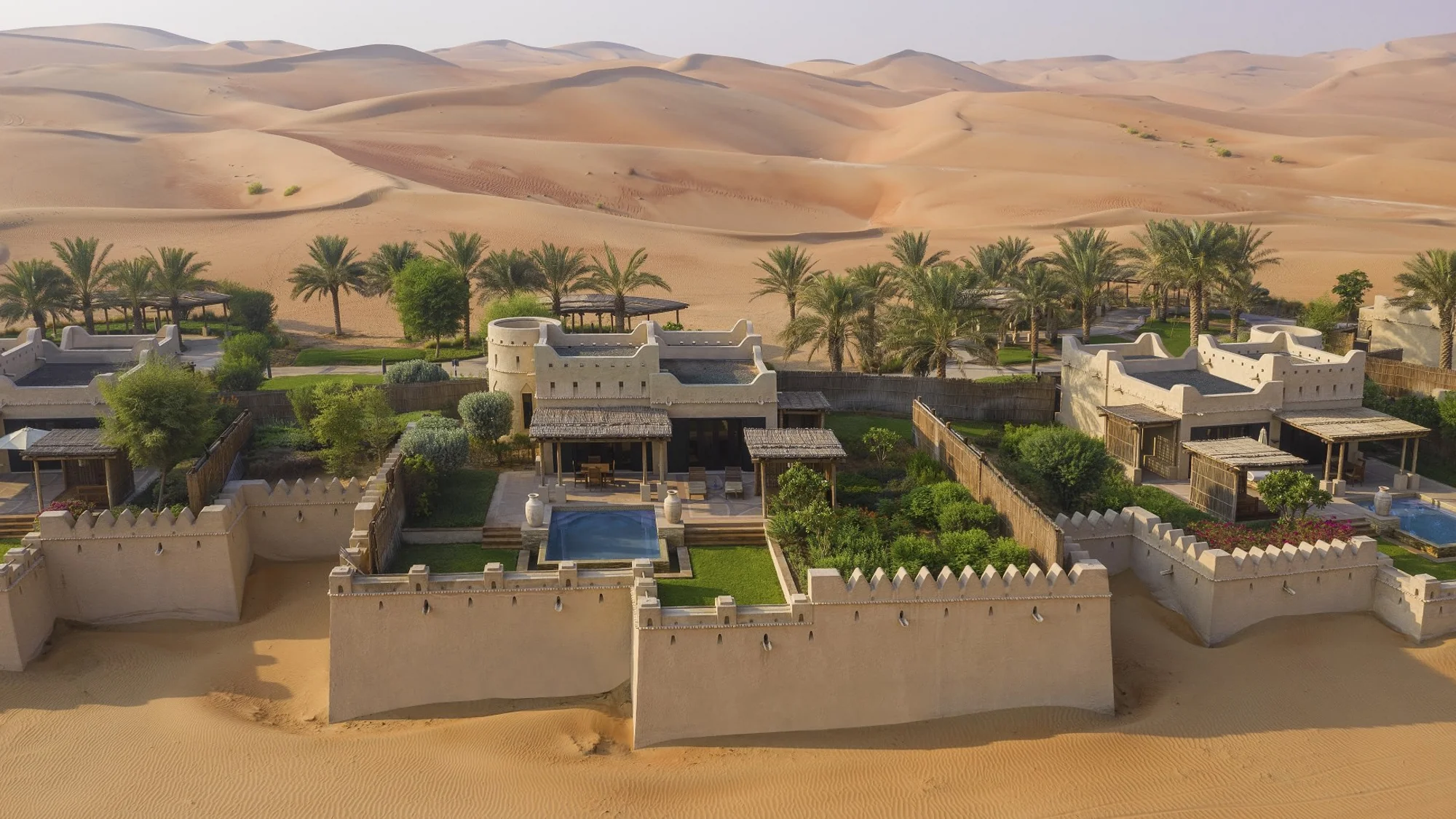 Luxury pool villa exterior in the desert.