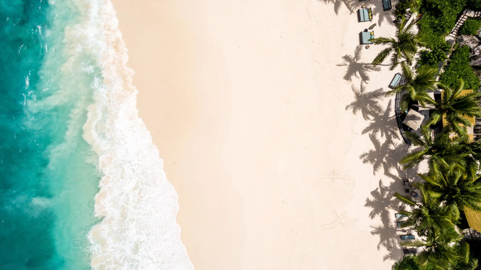 Anse Bambous beach on Fregate Island with pristine white sand and turquoise waters.