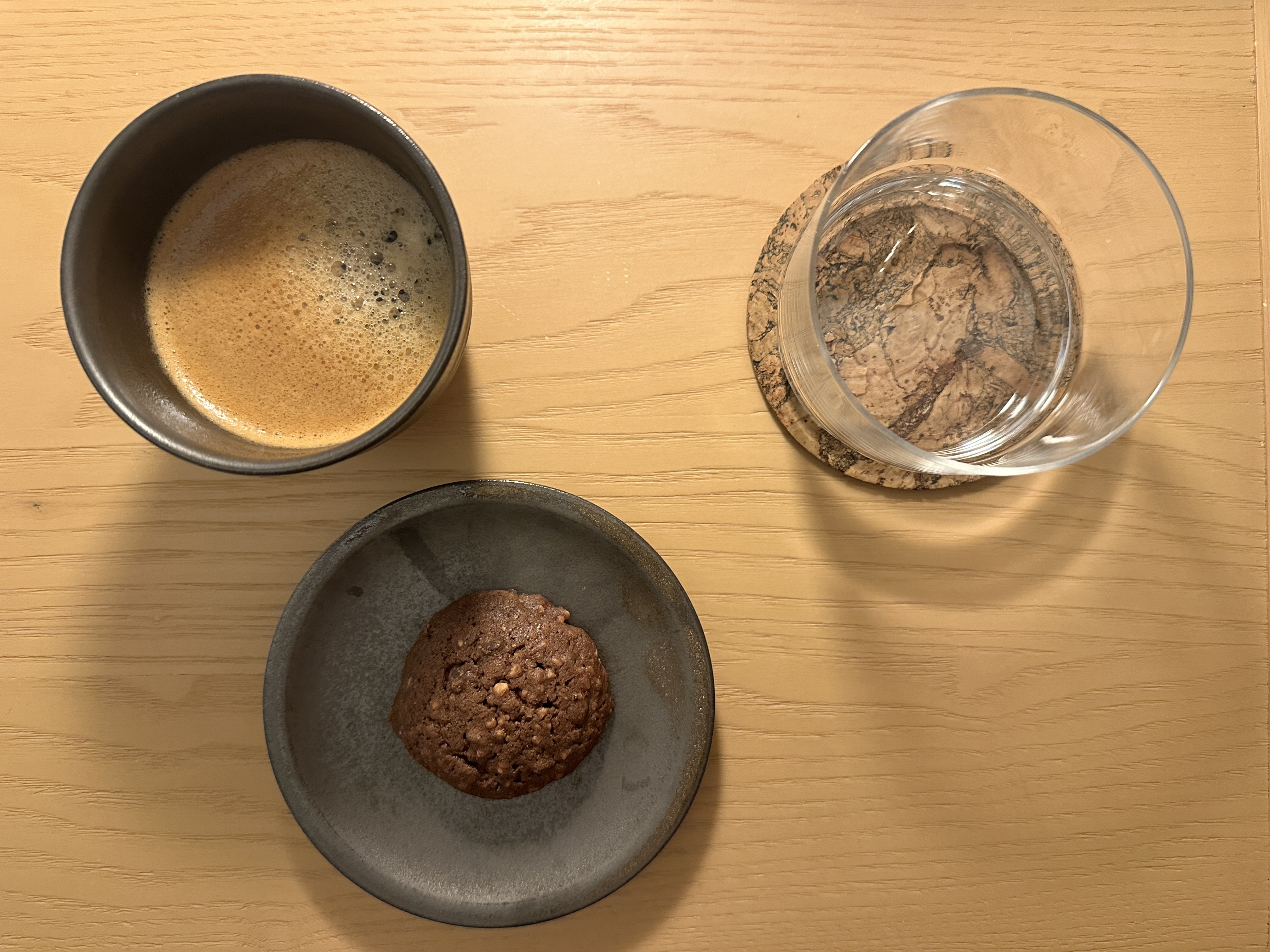 Close-up of the in-room coffee, sensha pepper chocolate chip cookie, and water.