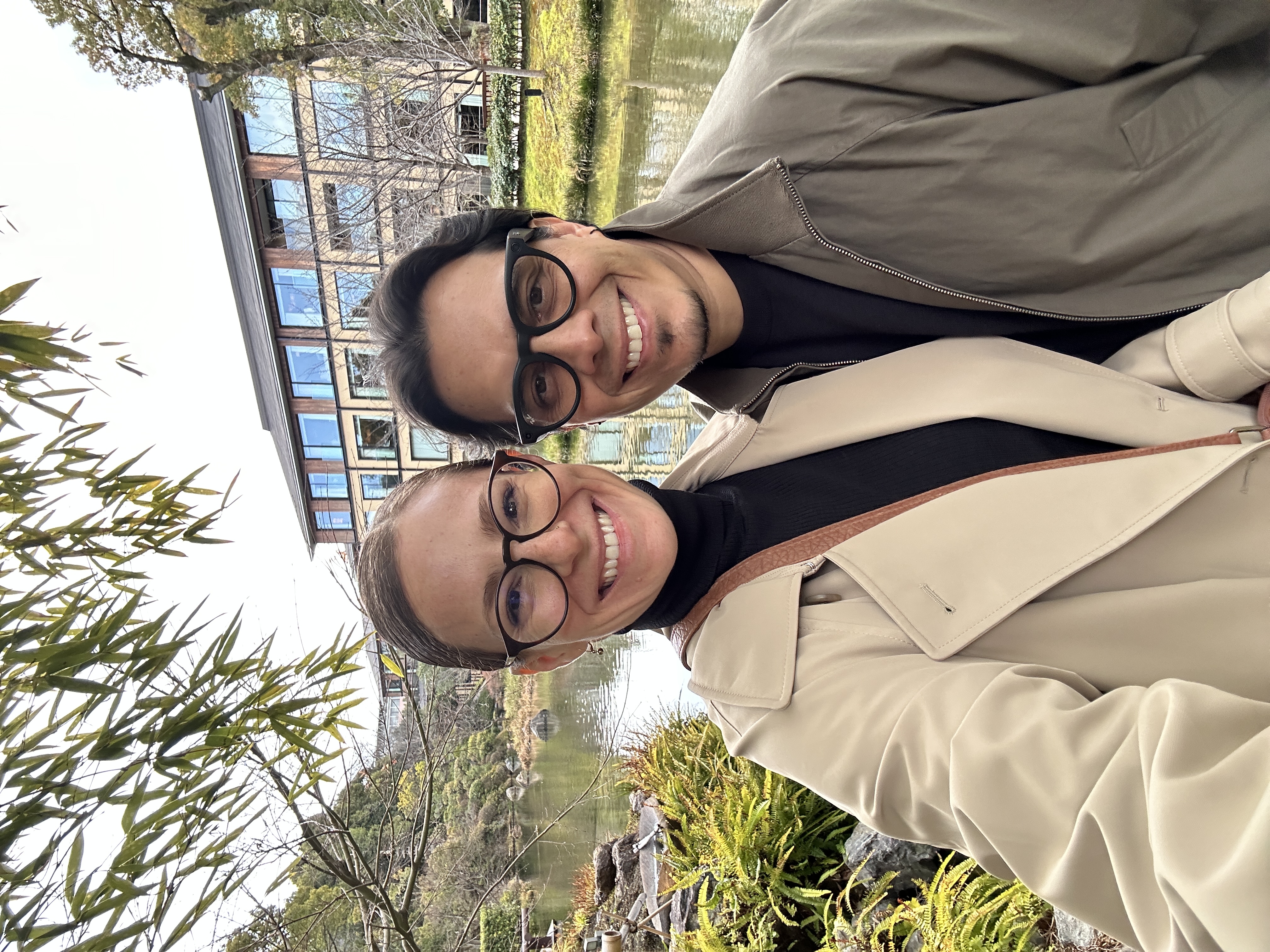 Krystal Ariel and Israel Pasos smiling together in front of the Shakusui-en pond garden at Four Seasons Kyoto.