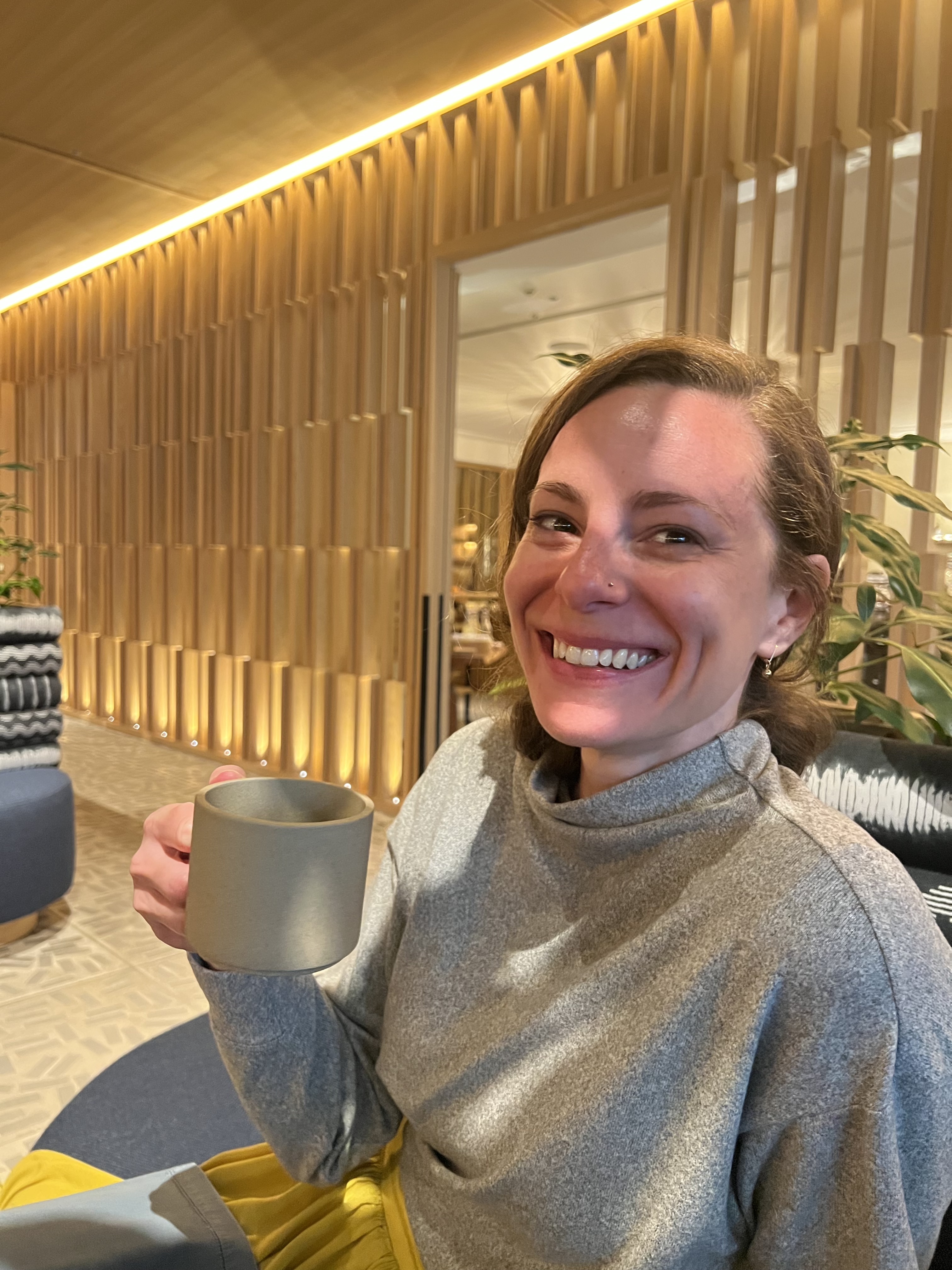A woman at Sekkei holding a cup of coffee