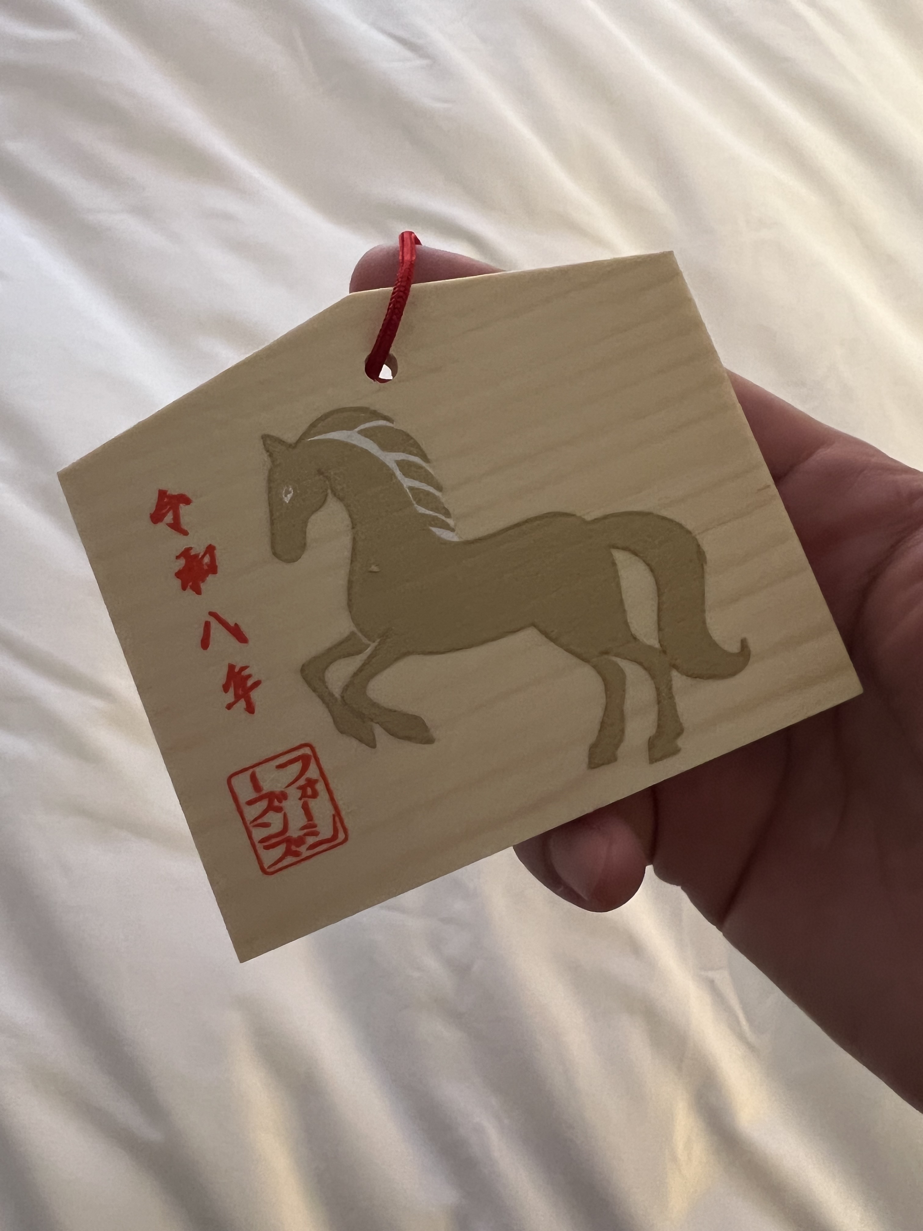 A small wooden ema prayer plaque.