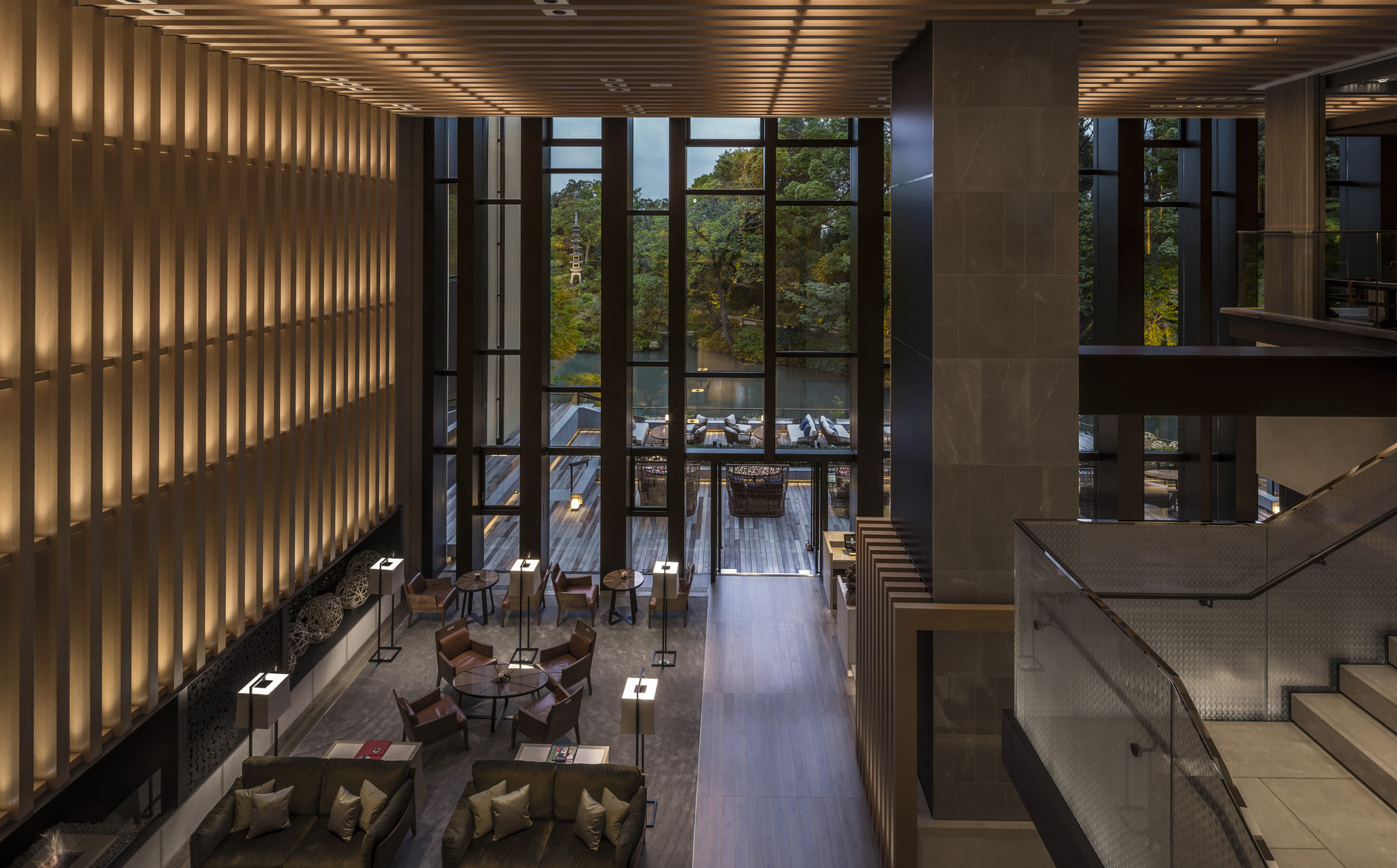 Four Seasons Kyoto lobby with floor-to-ceiling windows framing views of the pond garden.