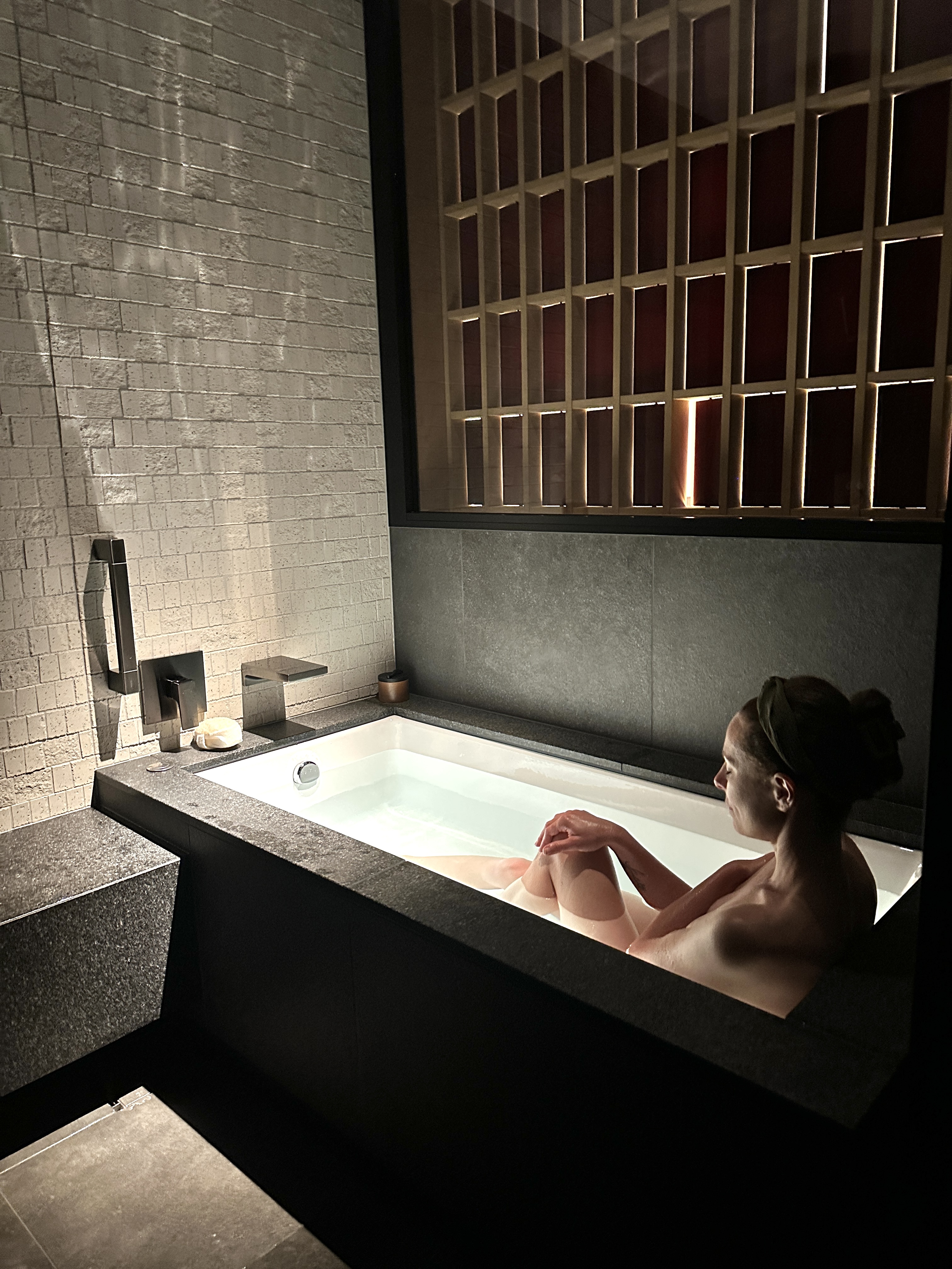 Krystal Ariel bathing in black stone tub at Six Senses Kyoto