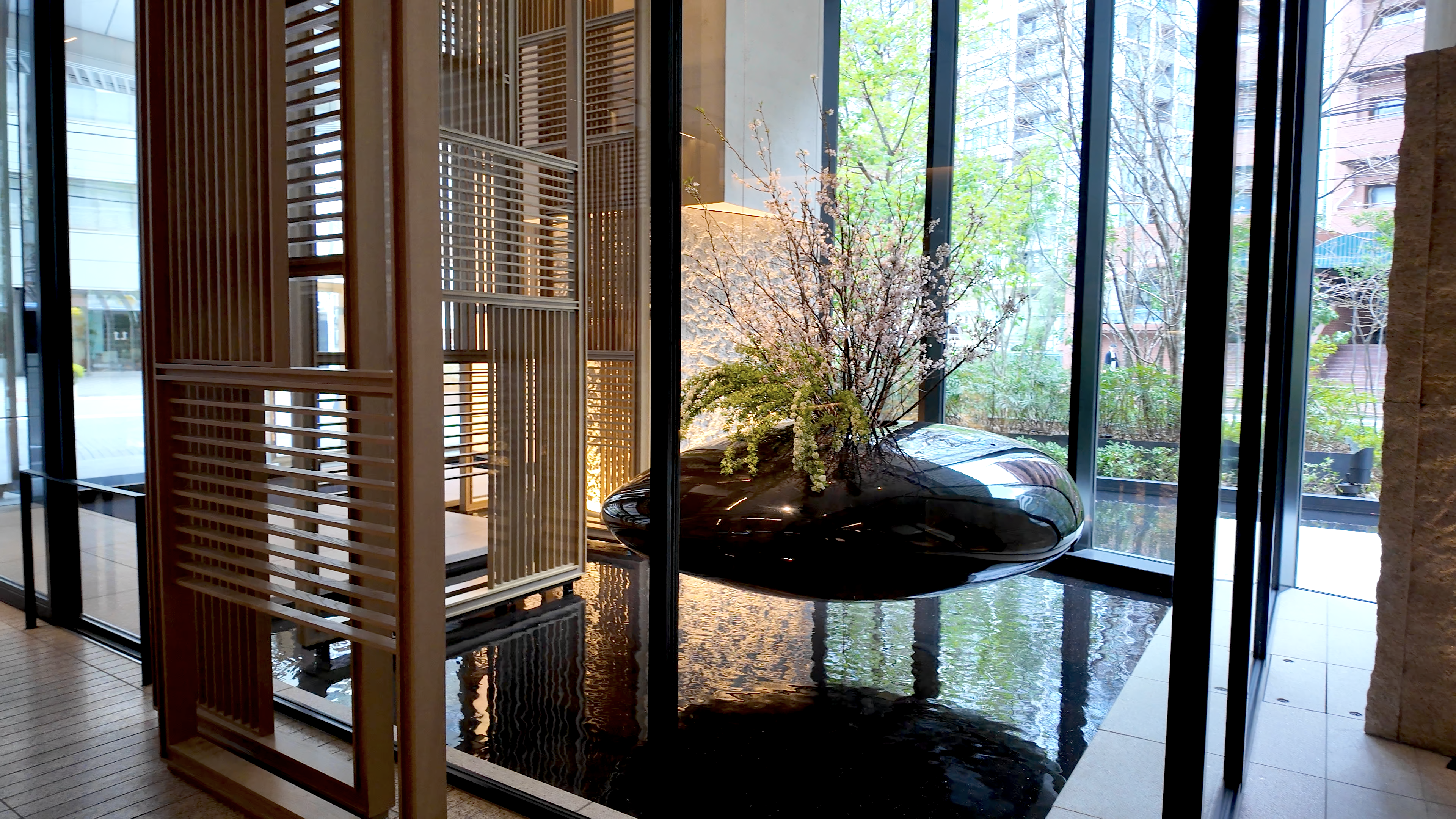 The lobby with a floating black bean and first blooms of sakura at the Four Seasons Osaka.